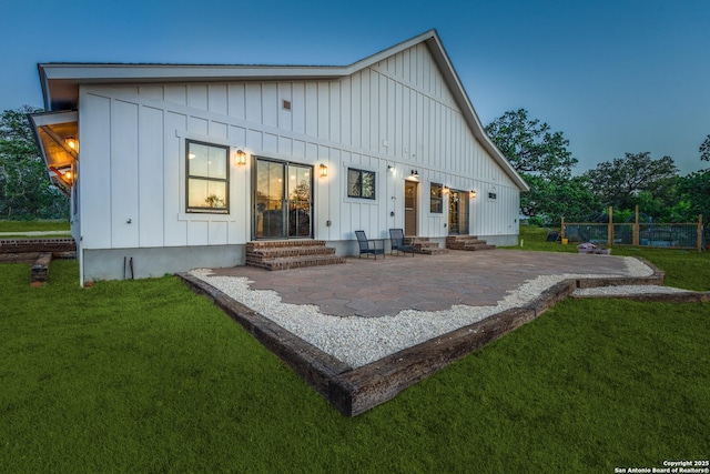 841 Postert, Floresville, TX 78114 - back of house featuring a patio, a yard, board and batten siding, and entry steps