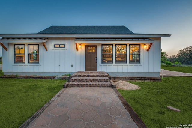 841 Postert, Floresville, TX 78114 - view of front facade featuring board and batten siding, a yard, and roof with shingles