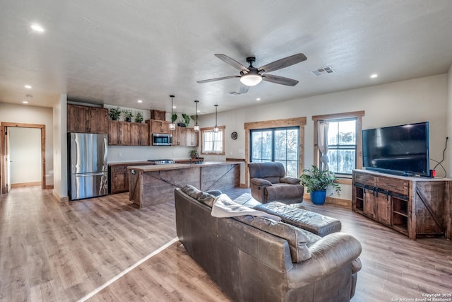 841 Postert, Floresville, TX 78114 - living area with recessed lighting, visible vents, a ceiling fan, and a healthy amount of sunlight