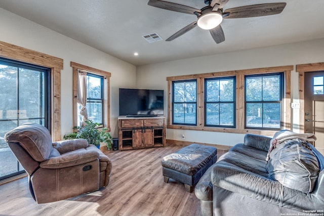 841 Postert, Floresville, TX 78114 - living area featuring plenty of natural light, wood finished floors, visible vents, and ceiling fan