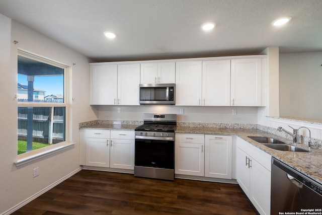 13711 Crossbow, San Antonio, TX 78253 - kitchen featuring white cabinets, light stone counters, a sink, appliances with stainless steel finishes, and dark wood-style flooring