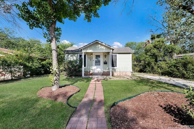 bungalow-style home featuring a front yard