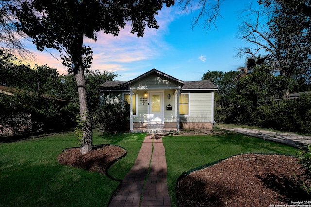 bungalow-style home featuring a yard
