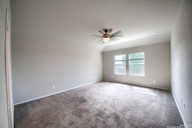 carpeted empty room with baseboards and ceiling fan