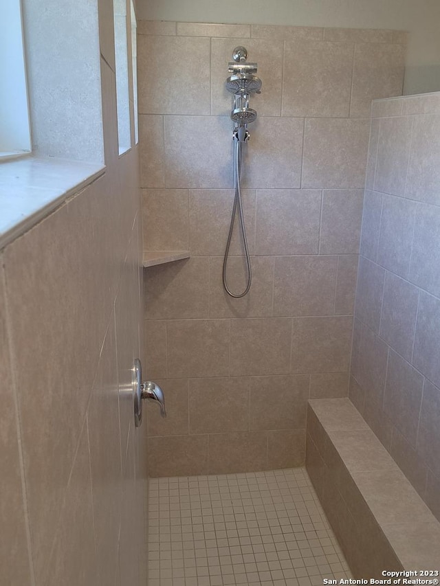 bathroom with a tile shower