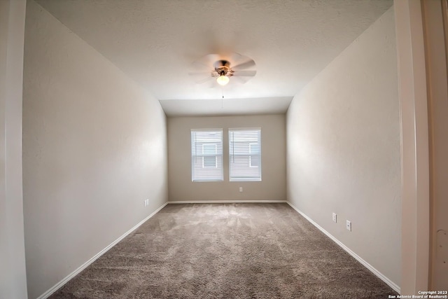spare room featuring carpet flooring, baseboards, and ceiling fan