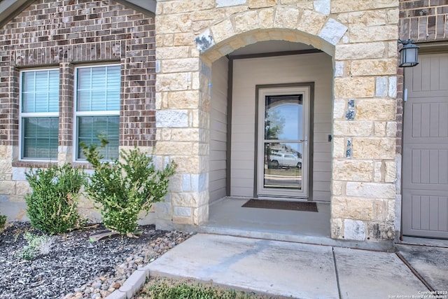 doorway to property with stone siding