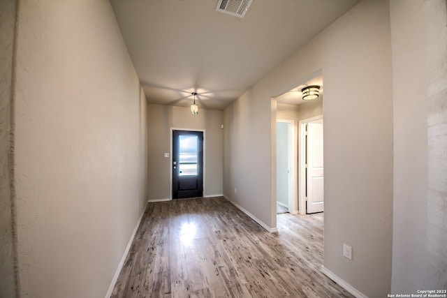 entrance foyer featuring baseboards, wood finished floors, and visible vents