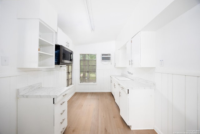 170 Olga, San Antonio, TX 78237 - kitchen featuring light countertops, a sink, stainless steel microwave, and light wood-style flooring