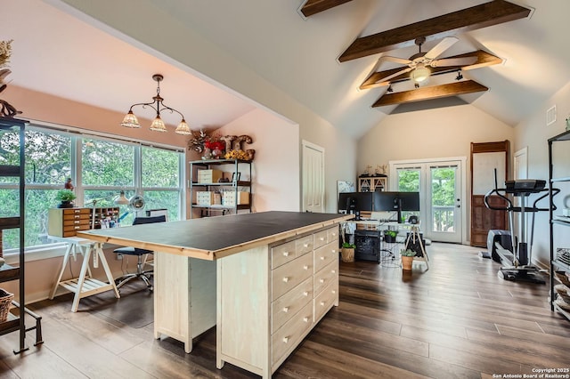 kitchen featuring lofted ceiling with beams, plenty of natural light, and tile countertops