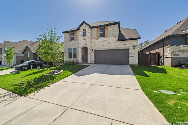 french country style house featuring stone siding, an attached garage, a front lawn, and concrete driveway
