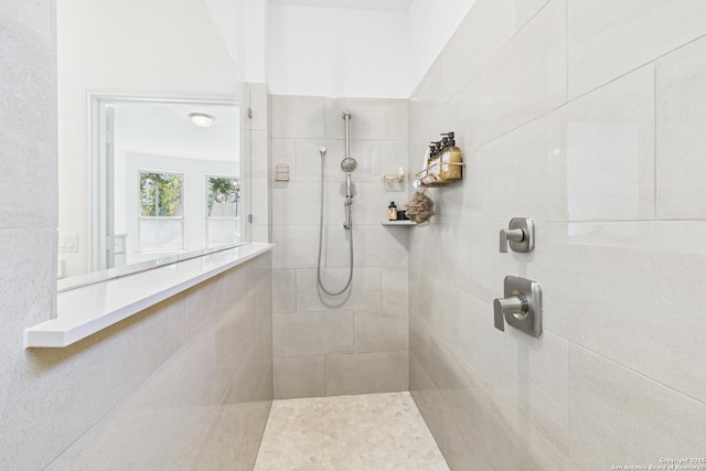 bathroom with a tile shower