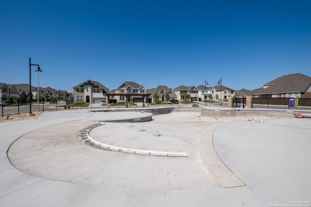 view of home's community with fence and a residential view