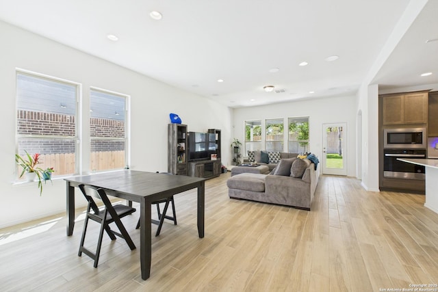 living room with recessed lighting, light wood-type flooring, and visible vents