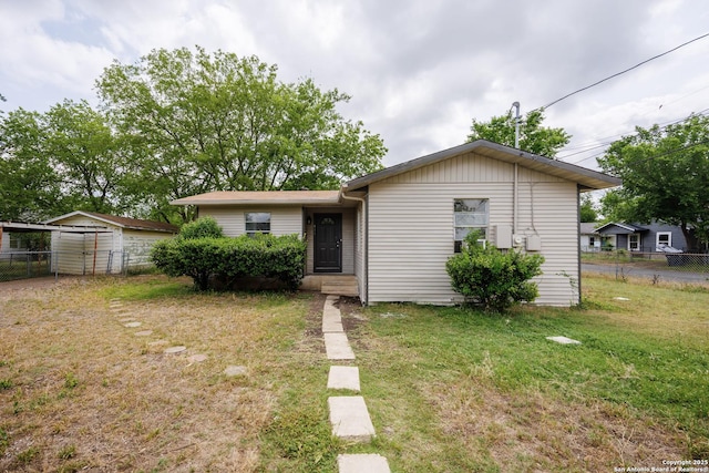411 Legette, Seguin, TX 78155 - view of front of house featuring an outdoor structure, a front lawn, and fence