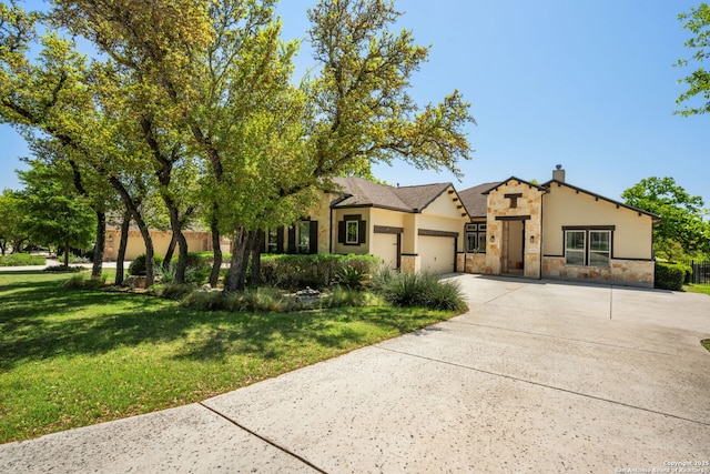 30336 Setterfeld Cir, Fair Oaks Ranch, TX 78015 - view of front of home with concrete driveway, a front lawn, stone siding, an attached garage, and stucco siding
