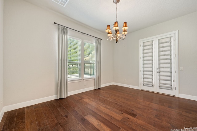 30336 Setterfeld Cir, Fair Oaks Ranch, TX 78015 - empty room featuring baseboards, a notable chandelier, dark wood-type flooring, and visible vents