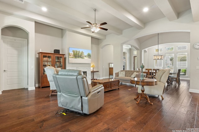 30336 Setterfeld Cir, Fair Oaks Ranch, TX 78015 - living area featuring ceiling fan with notable chandelier, arched walkways, beam ceiling, dark wood-style floors, and recessed lighting