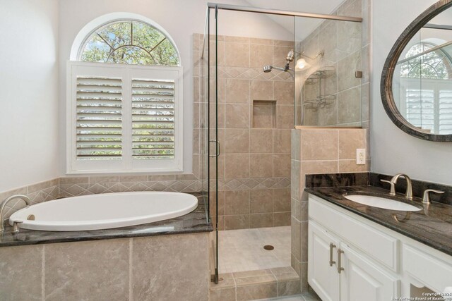 full bathroom featuring a shower stall, a bath, and plenty of natural light