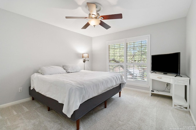 carpeted bedroom with baseboards and ceiling fan