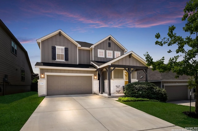 craftsman-style house featuring concrete driveway, board and batten siding, and a front yard