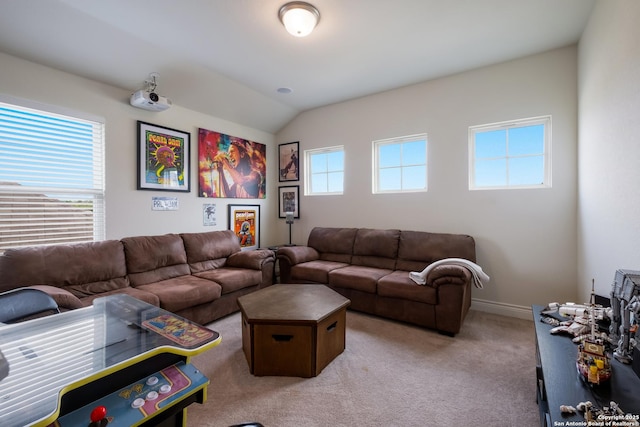 living area with vaulted ceiling, baseboards, and light carpet