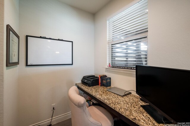office area with baseboards, a healthy amount of sunlight, and wood finished floors