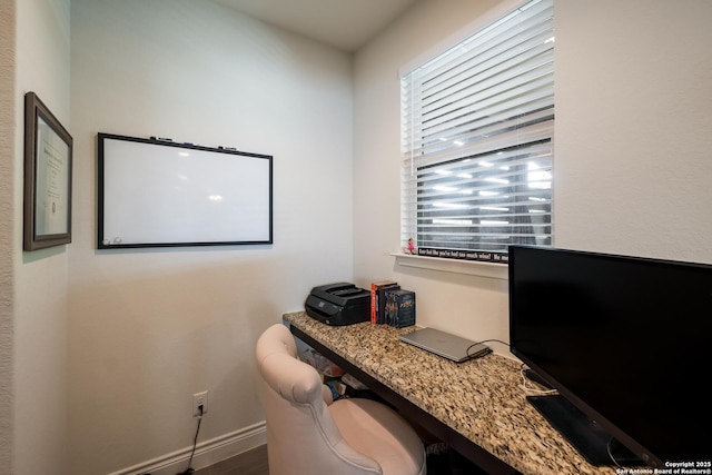 office area with baseboards, a healthy amount of sunlight, and wood finished floors