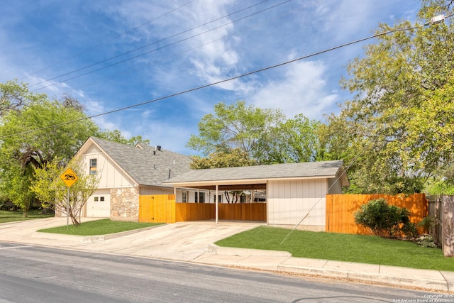 3102 Mindoro, San Antonio, TX 78217 - view of front of property with fence, a front lawn, driveway, stone siding, and a carport