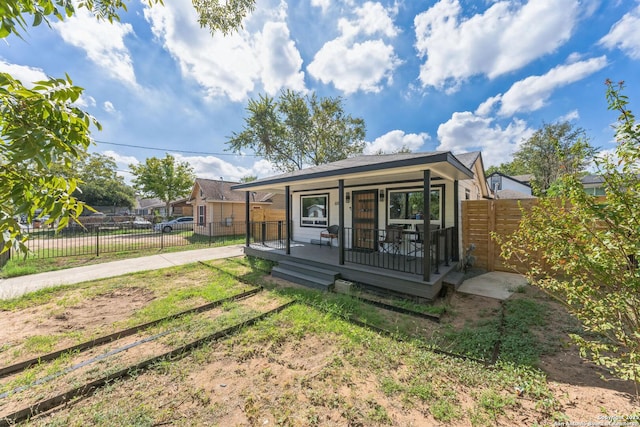 exterior space with fence and a porch