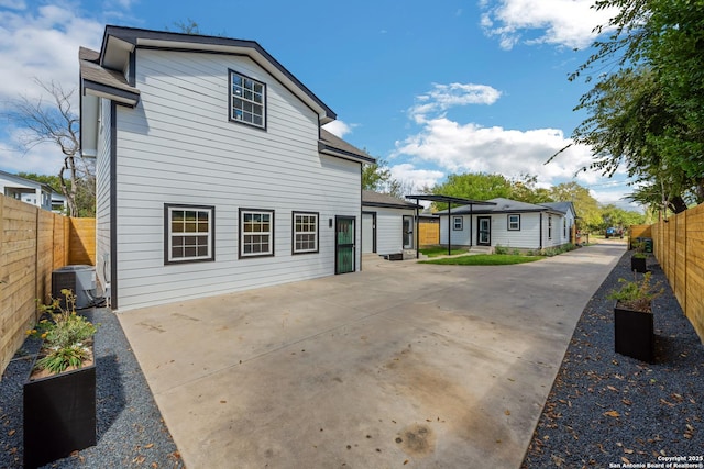back of house with cooling unit, a patio area, and a fenced backyard