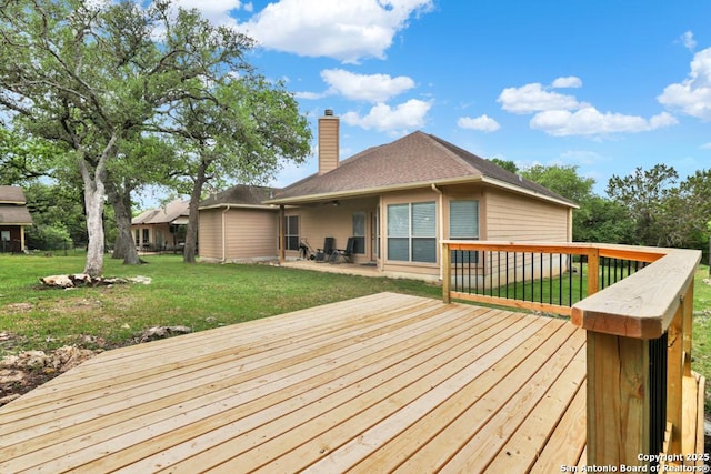 deck featuring a yard and a patio area