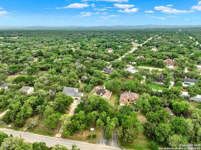 birds eye view of property with a wooded view