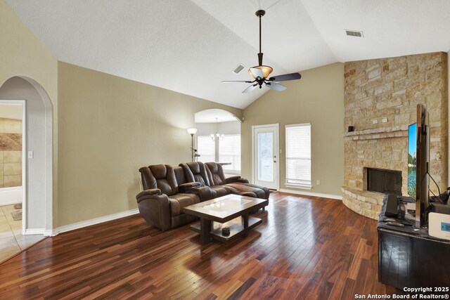 living area with ceiling fan, arched walkways, and wood-type flooring