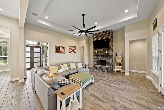 132 Ash Pkwy, La Vernia, TX 78121 - living room with a ceiling fan, a tray ceiling, and wood finish floors
