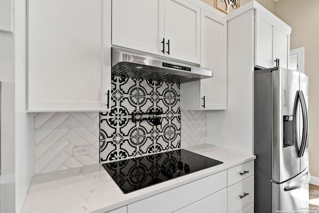132 Ash Pkwy, La Vernia, TX 78121 - kitchen featuring backsplash, under cabinet range hood, white cabinetry, and stainless steel fridge