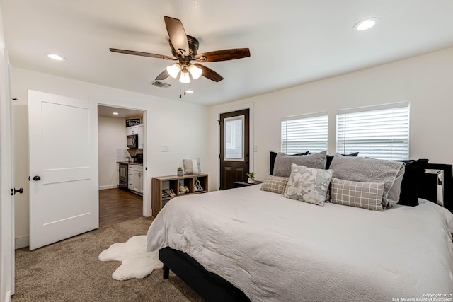 carpeted bedroom with a ceiling fan, visible vents, and recessed lighting