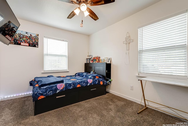 carpeted bedroom featuring baseboards and a ceiling fan