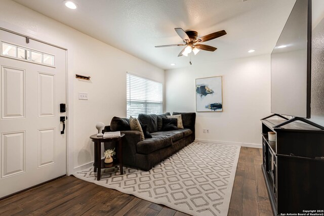 living area with recessed lighting, wood finished floors, a ceiling fan, and baseboards