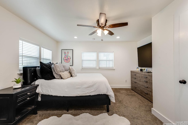 carpeted bedroom with a ceiling fan, baseboards, recessed lighting, and multiple windows