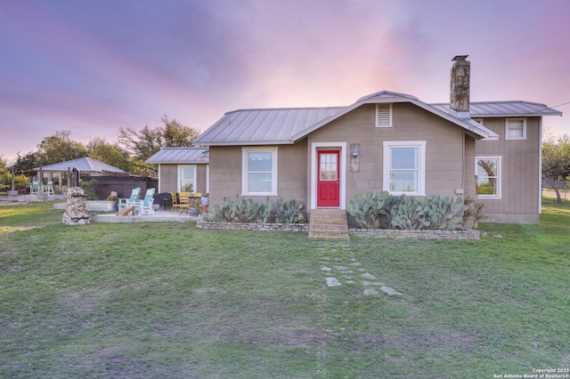283 N Second St, Harper, TX 78631 - ranch-style home featuring a yard, a patio area, a chimney, and metal roof