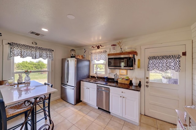 283 N Second St, Harper, TX 78631 - kitchen featuring visible vents, appliances with stainless steel finishes, white cabinetry, and light tile patterned floors