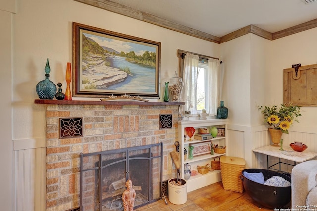 283 N Second St, Harper, TX 78631 - living area featuring a fireplace, crown molding, wood finished floors, and a wainscoted wall
