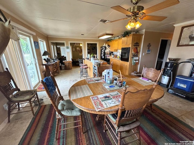 dining room with a ceiling fan and visible vents