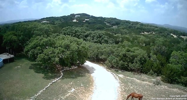 drone / aerial view featuring a forest view