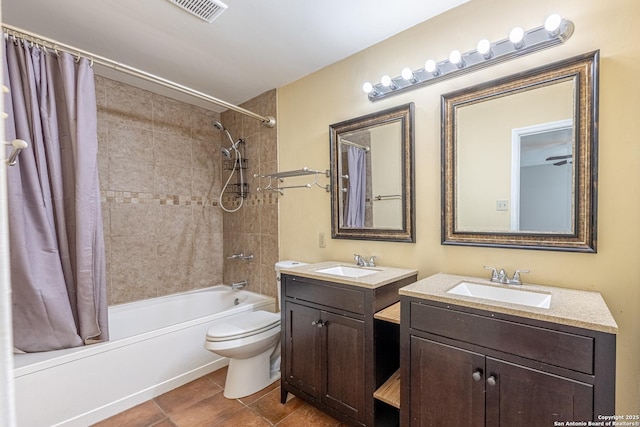 bathroom with shower / bath combination with curtain, toilet, a sink, and visible vents