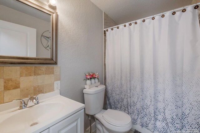 911 Porter St, San Antonio, TX 78210 - bathroom featuring a textured ceiling, vanity, a shower with curtain, a textured wall, and toilet