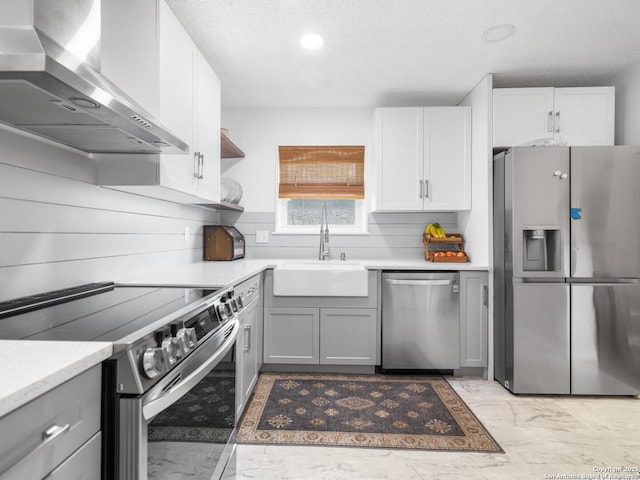 7906 Winsford, San Antonio, TX 78239 - kitchen featuring wall chimney range hood, a sink, gray cabinets, marble finish floor, and stainless steel appliances