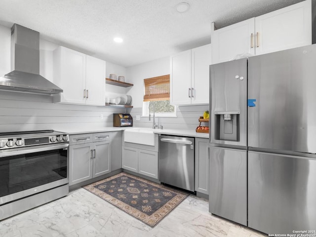 7906 Winsford, San Antonio, TX 78239 - kitchen with a textured ceiling, wall chimney exhaust hood, marble finish floor, and stainless steel appliances