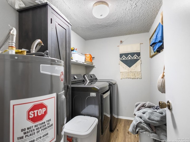 7906 Winsford, San Antonio, TX 78239 - laundry area with wood finished floors, a textured ceiling, separate washer and dryer, water heater, and laundry area